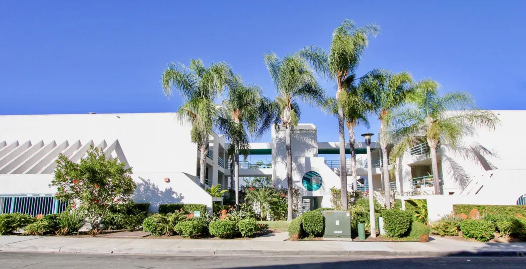 THE HOUSE IN THE LA COSTA GREENS WITH THE BALCONIS, TREES, THAR ROAD, ELECTRIC BOX