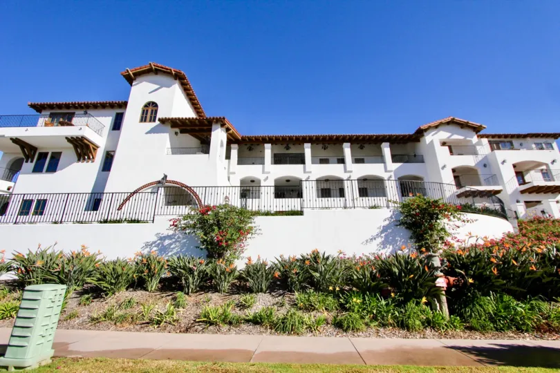 THE BUILDING IN THE LA COSTA RESORT VILLAS WITH THE PATHWAY, FLOWER PLANTS, STEEL WALL