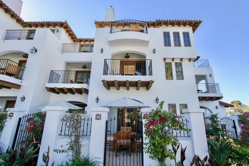 THE APARTMENT IN THE LA COSTA RESORT VILLAS WITH THE WOODEN CHAIR, FLOWER PLANTS, TREES, BALCONIS, LIGHTS