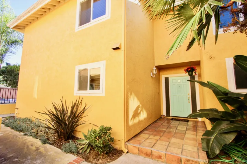THE BUNGALOW IN THE LA COSTA SOUTH WITH THE WOODEN DOOR, LAMP, FLOWER POT