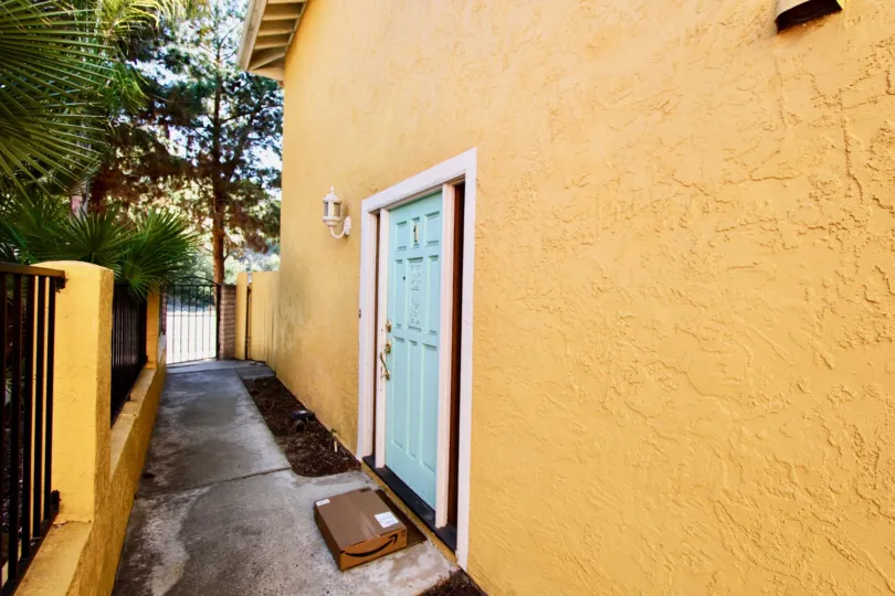 THE APARTMENT IN THE LA COSTA SOUTH WITH THE WOODEN DOOR, PATHWAY, STEEL GATE, TREES, LIGHT