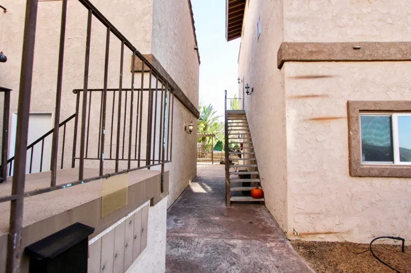 A SIGHT OF CORRIDOR IN THE MIDDLE OF TWO PEACH COLOURED BUILDING