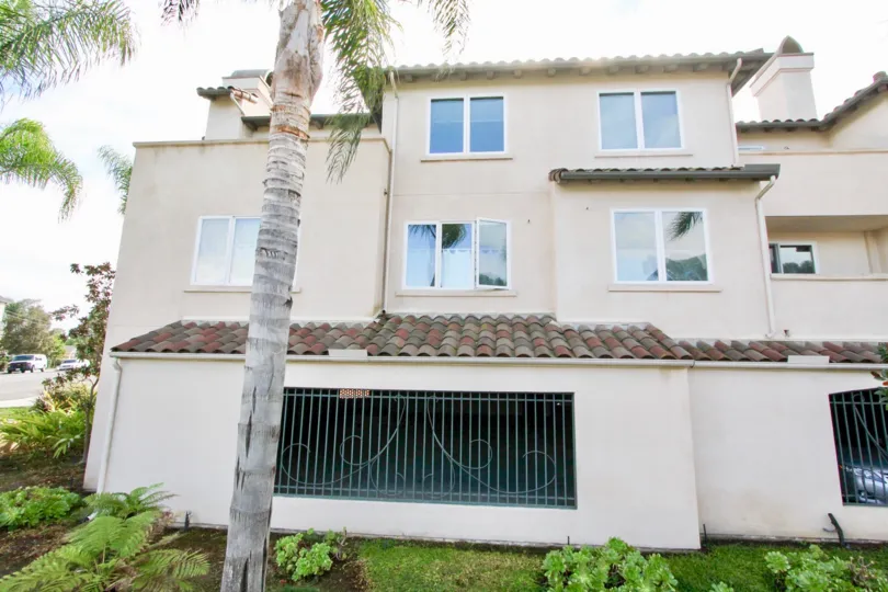 This multilevel Laguna Point home boasts lots of windows and wrought iron touches.