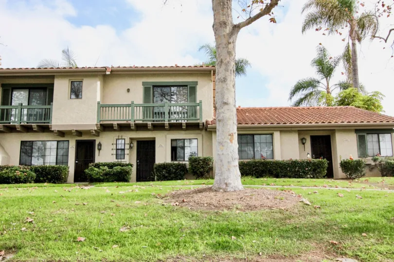 Bungalow and two storey side-by-side homes with large front lawns and mature trees at Las Playas