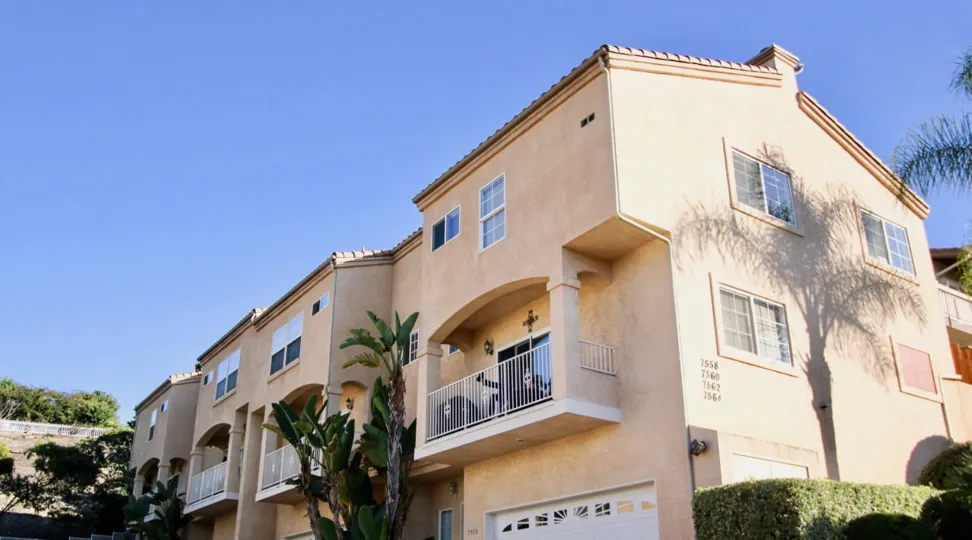 A sunny day in the Meadowview Townhomes with a big building.
