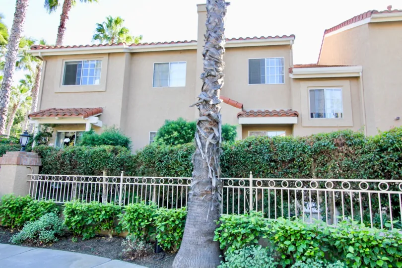 Trees with garden and sunshine in front of villa in Monarch Villas of Carlsbad