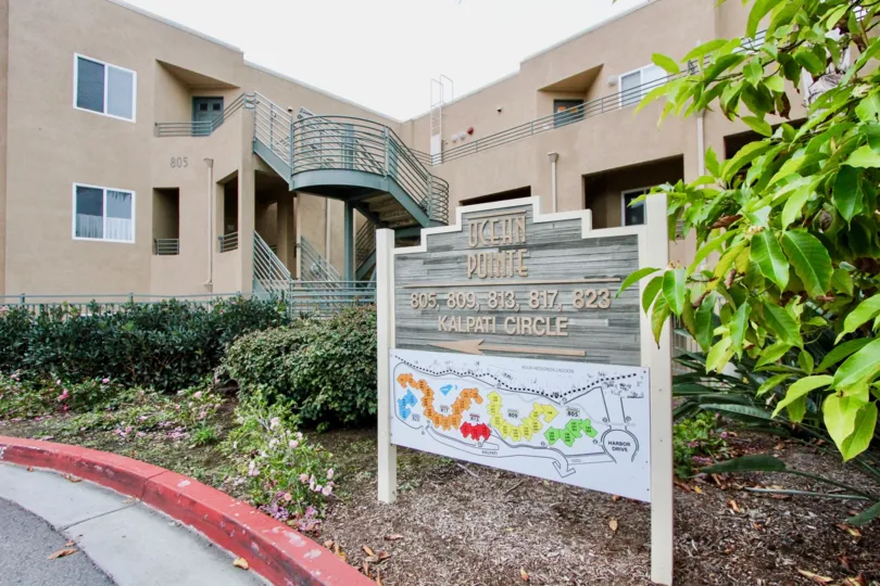 A rainbow colored map underneath a community sign at Ocean Pointe in Carlsbad CA