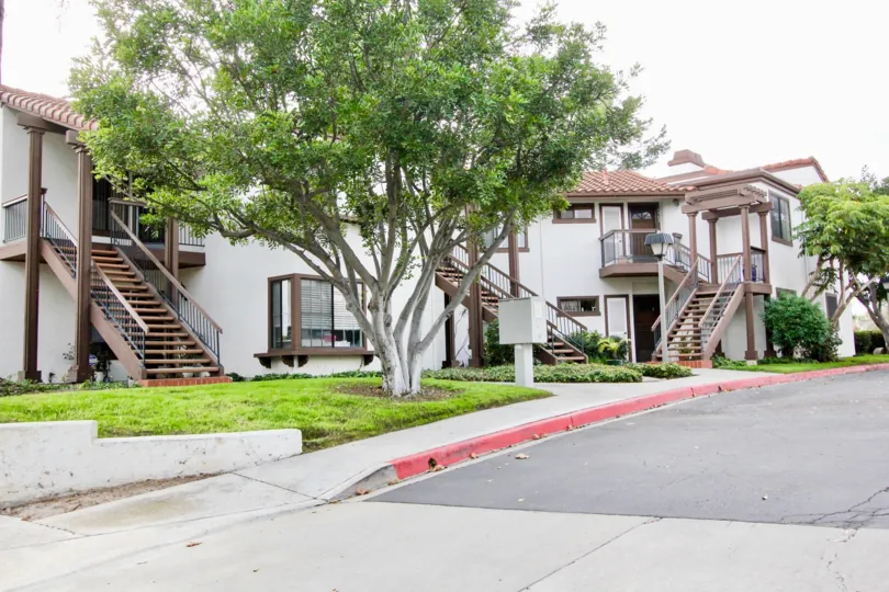 Front roadside view with trees of Paseo De La Costa community, Carlsbad, CA