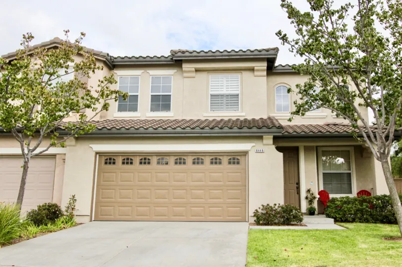 A bright day in the Poinsettia Heights with a building and wooden door.