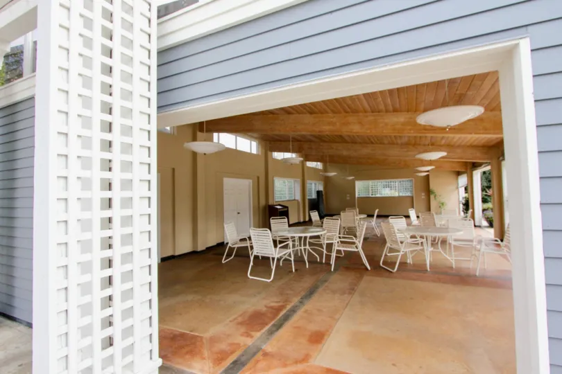 A day in the Sea Cliff with a hall and white chairs.