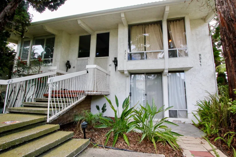 Beautiful entrance steps to a villa with glass doors and plants in Sea View of Carlsbad