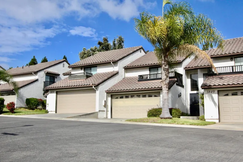 Some sweet villas near the road side in the Seaport Villas with small lawns and shrubs.