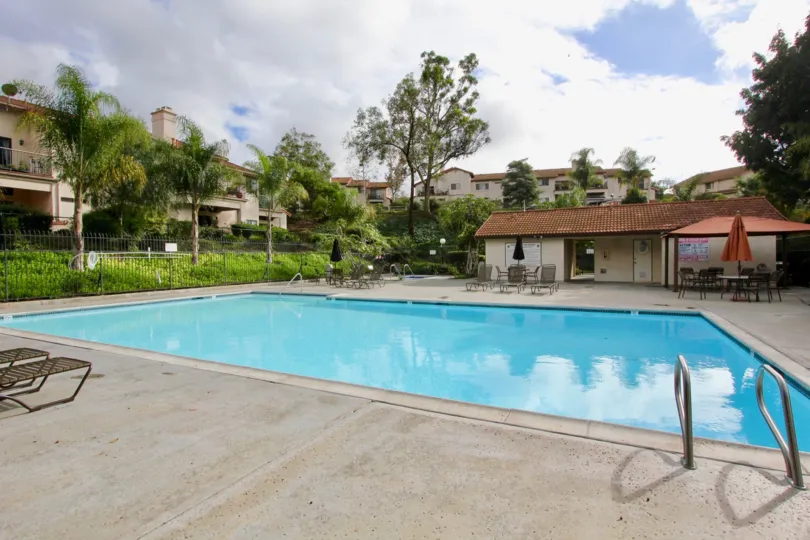 A cloudy day in the Villas with a large swimming pool.