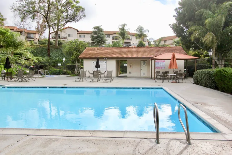 A cloudy day in the Vilas with a swimming pool and some chairs.