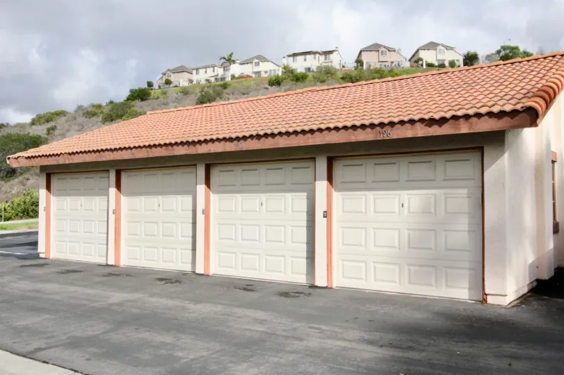 A cloudy day in the Villas with in front of a garage.