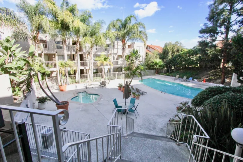 A beautiful day in the Tres Verde with swimming pools and some chairs.