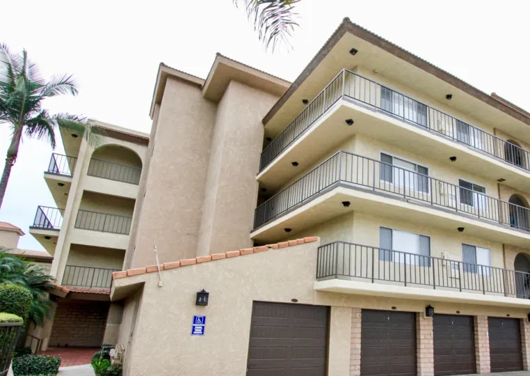 The balconies and garages with palm trees on side in the Tu Casa community