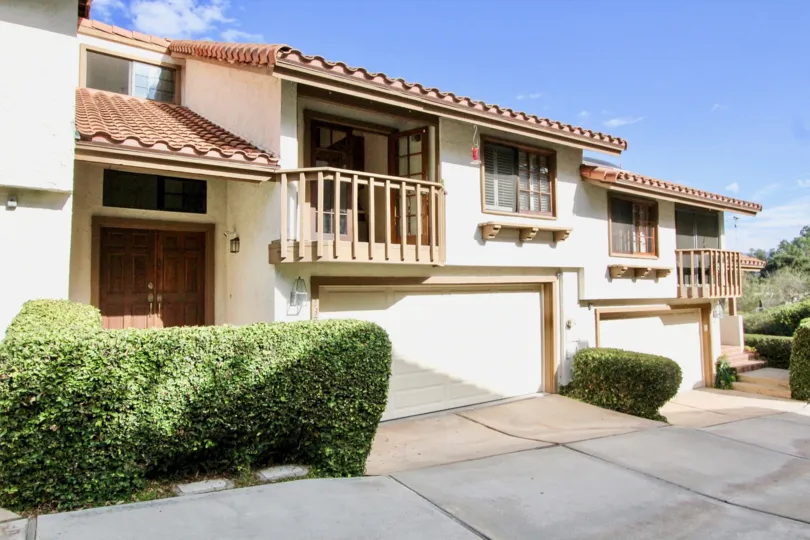 House with multiple balconies and garage in the Villa la Costa community