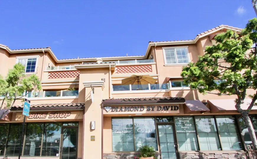 Storefront view of a local bike shop and jeweler in the Village by the Se community of Carlsbad, California