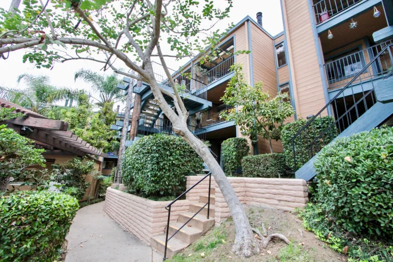 Decorated balconies are on display in Windsong Cove, where the units are surrounded by bushes and trees.