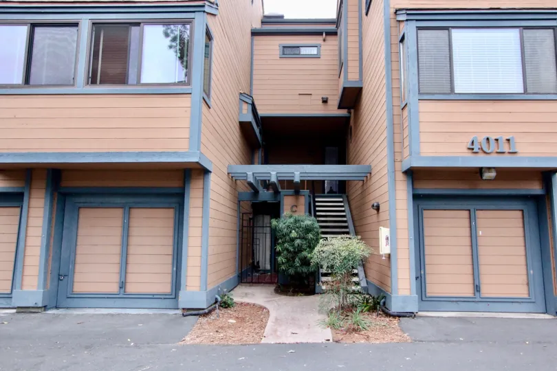 Between the Two apartments in Windsong Cove has way by stairs with bushes