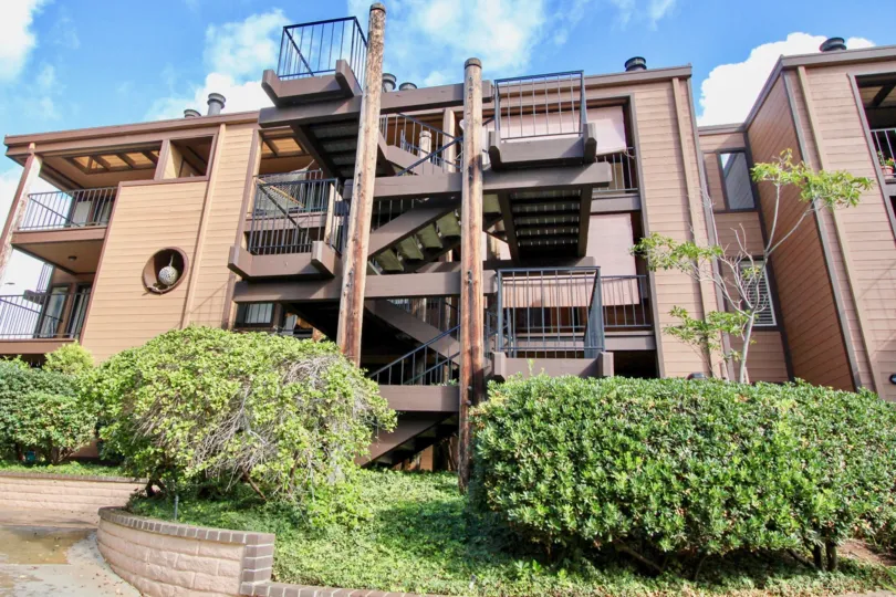 A sunny day in the Windsong Palms with a building and staircase.