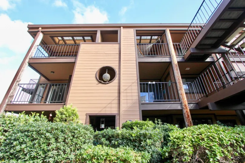 Street level view of condos at Windsong Palms in Carlsbad, CA on a sunny day