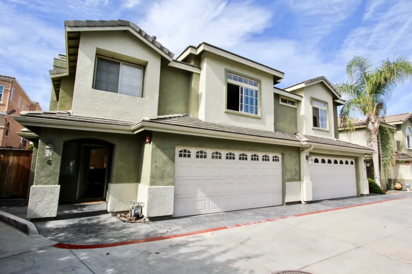 Two story housing with large white garage doors located at Ada Terrace in Chula Vista CA