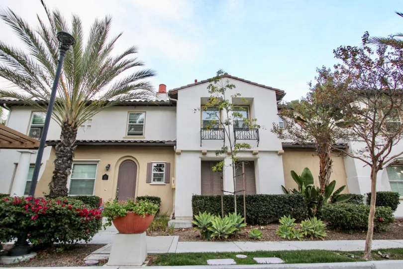 grand house with elegant look and subtle paint job in Agave with trees in front and greenery plenty