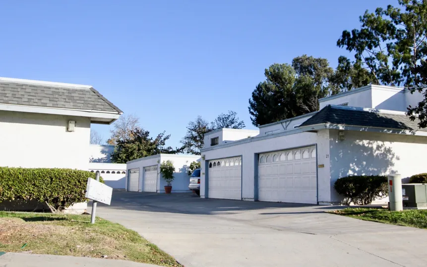 Blue sky and a driveway with garages in the Autumn Hills Community in Chula Vista, CA.