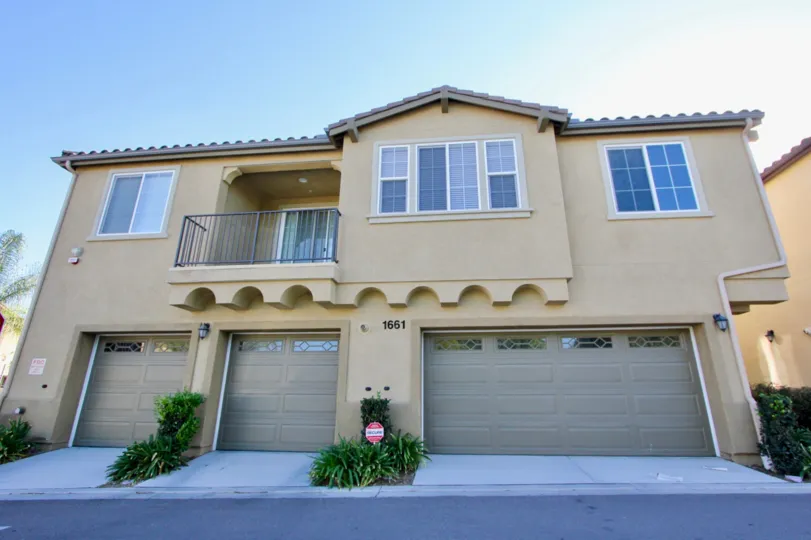 Two small garage doors sit near a long one at Avalon condos