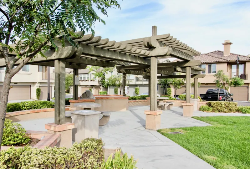 A covered seating area in the park of the Belleza community.
