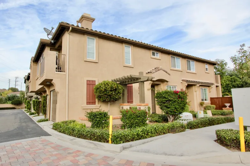 A Beautiful House surrounded by Trees and lawn on a sunny day in Belleza of Chula Vista City