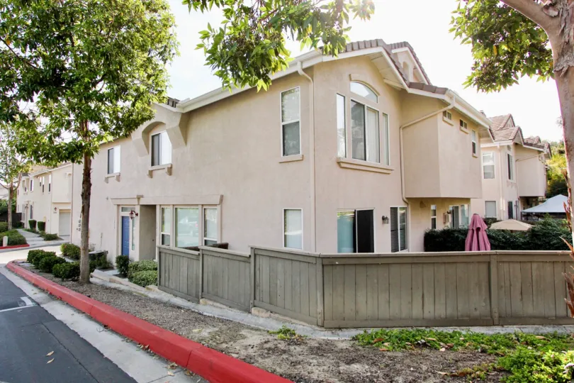 A bright red curb near a two story home with fence in Bolero at Chula Vista CA