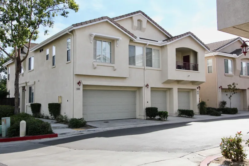A white two-story house and an empty street in Bolero neighborhood