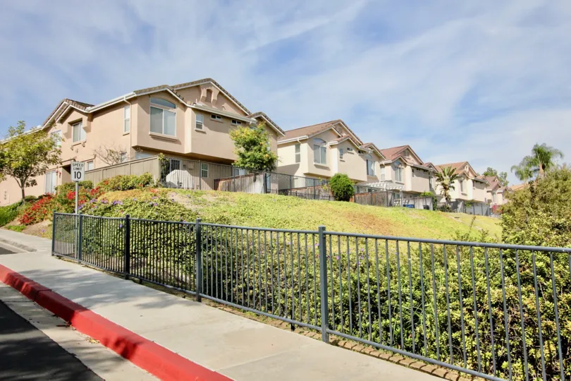Homes backing onto large greenspace with wrought iron fences in Chula Vista