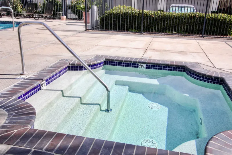 Bricks surround a hot tub on a patio at Bolero condos