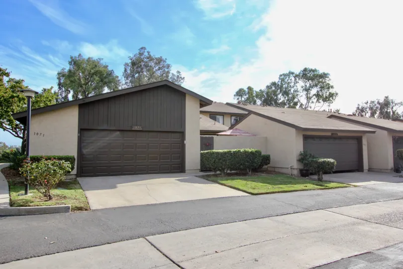 Detached double car garage on a wide backlane with small manicured lawns at Bonita Terrace