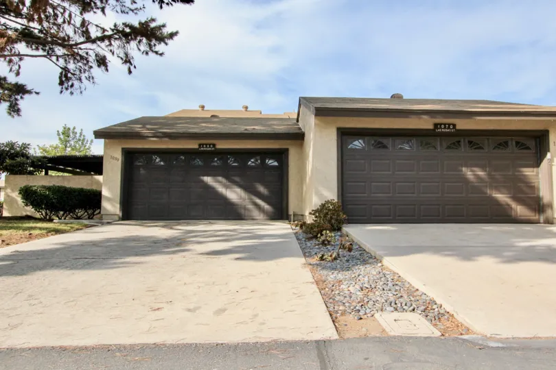 Double car tandem garages with rock lined median between units and plenty of trees at Bonita Terrace