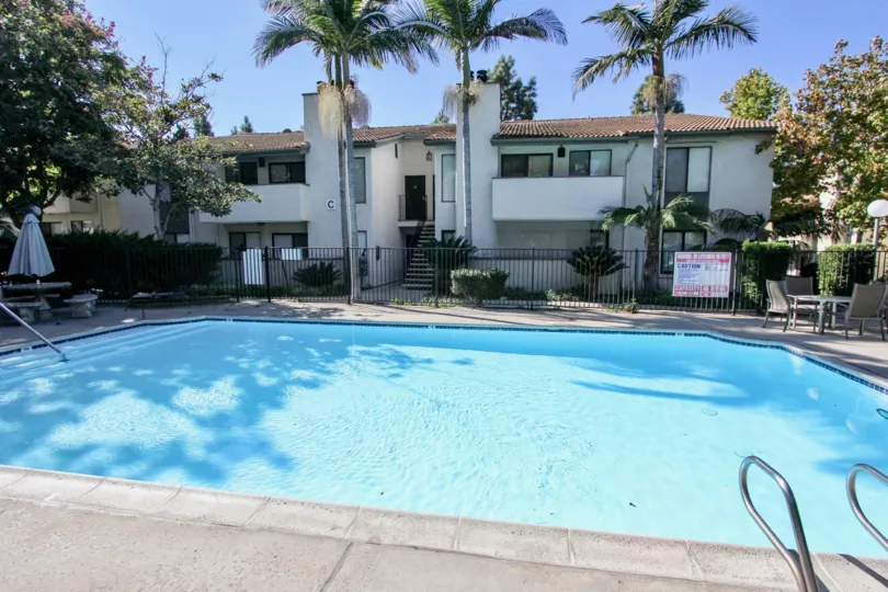 A very large blue pool surrounded by a fence in Chula Vista CA at Brentwood Arms