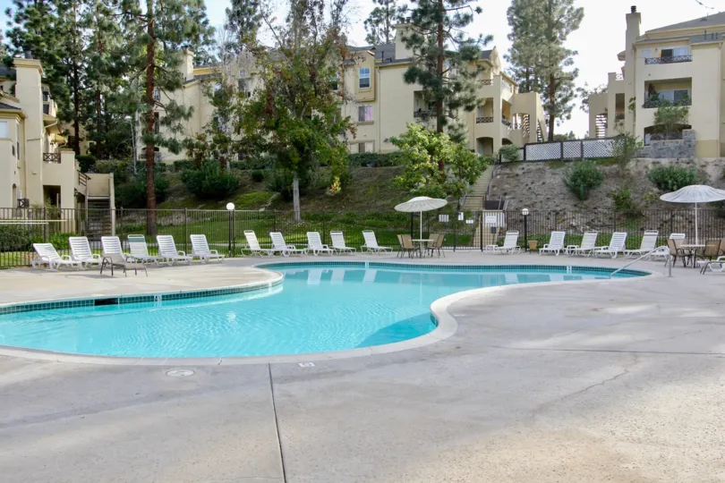 Private swimming pool with sizeable deck and ample seating in a secluded setting at Camelot