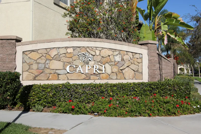 The manicured front entrance and sign of the Capri neighborhood
