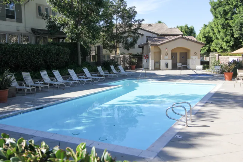 Swimming pool surrounded by pool chairs and change room for residents of Capri
