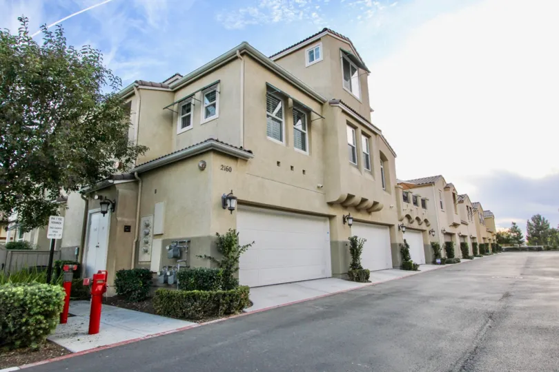 Partly cloudy day of apartment complexes in the Capria community in Chula Vista, California.