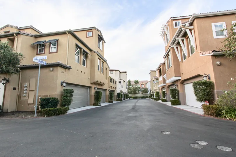A residential street in Capria with large, two story houses.