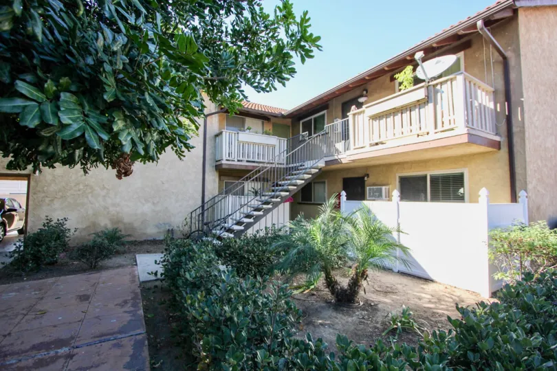 A sunny day in the Casa de Moss with many types of trees and the house at Chula Vista in California