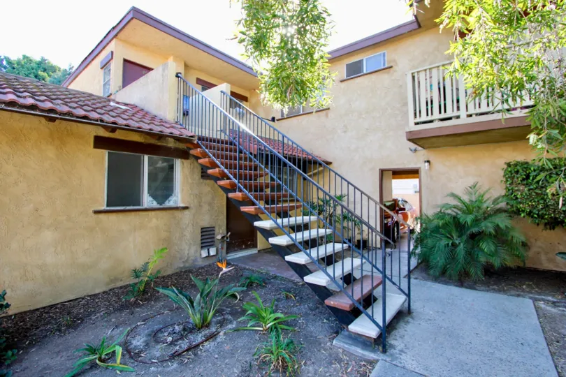 A sunny day in the area of Casa de Moss, stairs, car, garage, balcony, greenery, tree