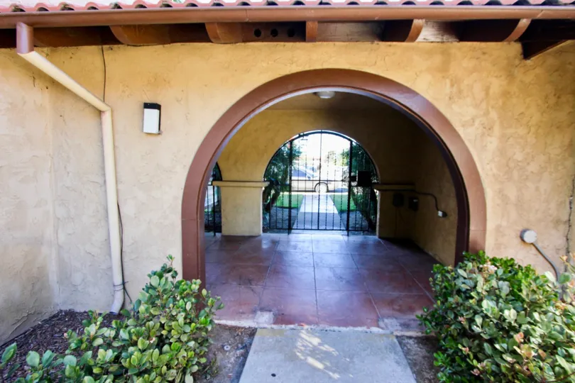 Interior view of the entry with large arches and secure gate door at Casa de Moss