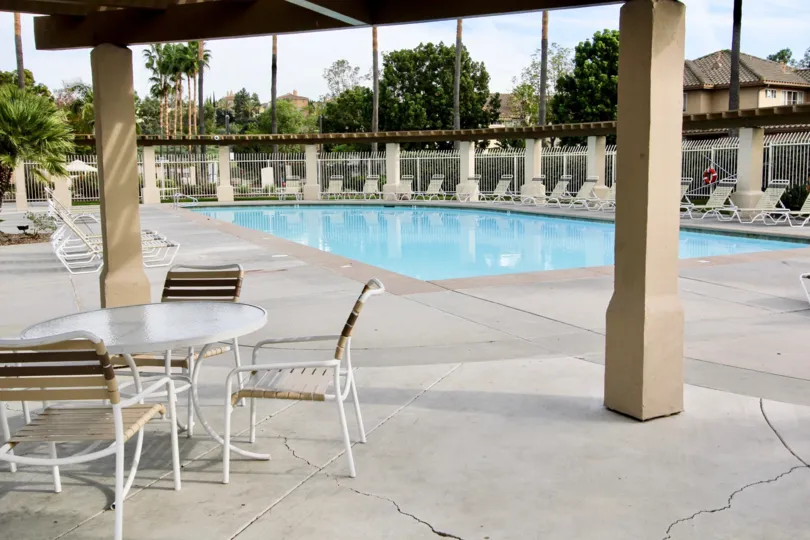 A clean poolside area in the Chapala neighborhood of Chula Vista, CA with tanning chairs and patio