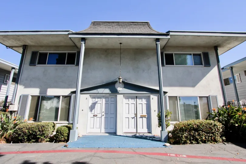 A red line of paint on the ground in front of a building in Chula Vista Townhomes